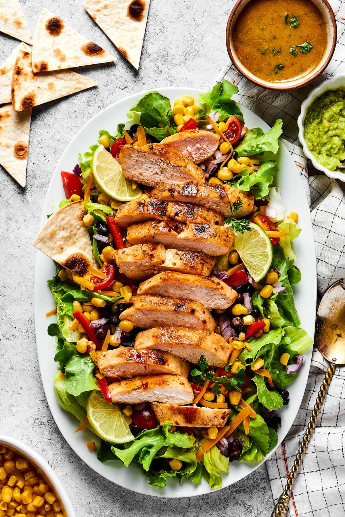 With ingredients like black beans, corn, bell pepper, and tomatoes, this Grilled Chicken Southwest Salad is bursting with flavor. Overhead view of southwest chicken salad