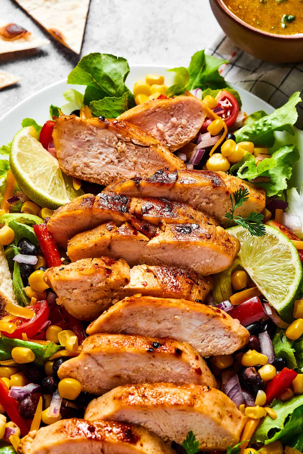 With ingredients like black beans, corn, bell pepper, and tomatoes, this Grilled Chicken Southwest Salad is bursting with flavor. Overhead viewofa grilled chicken salad