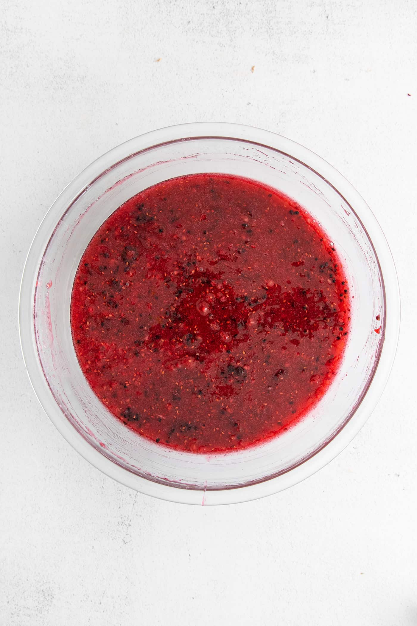 This Raspberry Blackberry Freezer Jam comes together in less than an hour, with just 4 ingredients. No cooking or canning is required! Raspberry freezer jam in a bowl