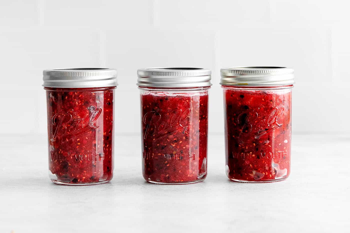 This Raspberry Blackberry Freezer Jam comes together in less than an hour, with just 4 ingredients. No cooking or canning is required! Three jars of raspberry blackberry freezer jam