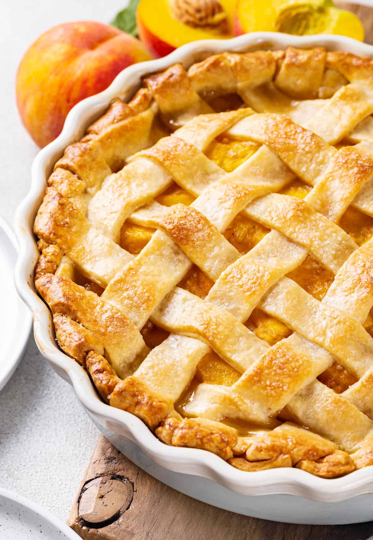Made with just 10 ingredients, this Homemade Peach Pie is perfectly spiced and topped with a beautiful golden brown flaky lattice crust. Overhead view of a freshly baked peach pie