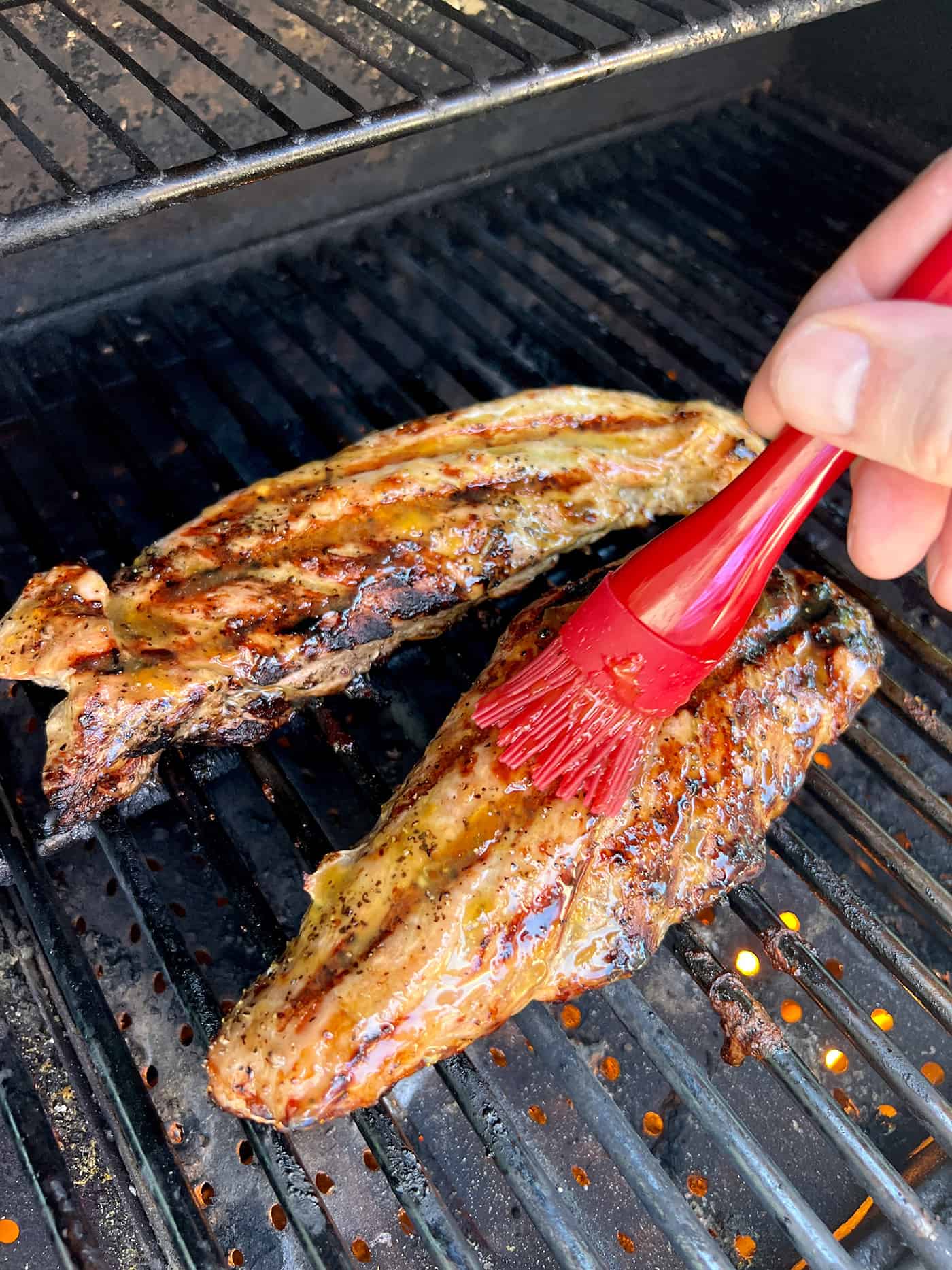 Tender, juicy Grilled Pork Tenderloin is glazed with a sweet peach sauce then topped with an orange-habanero mojo. Brushing peach glaze on pork tenderloins
