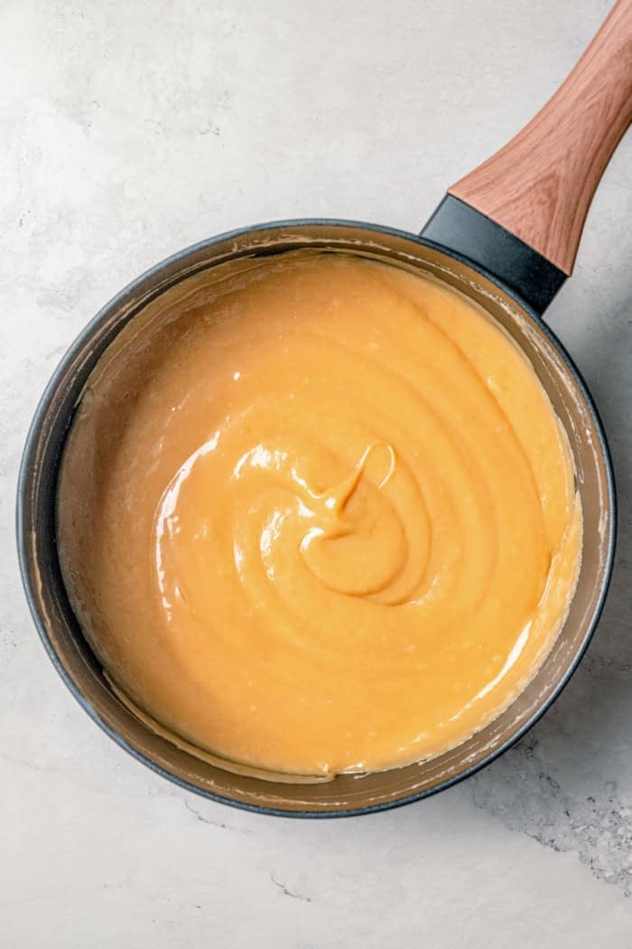 This Caramel Apple Dip beats the pants off of any store-bought caramel dips. Guaranteed! It’s also super easy to make with 3 ingredients. Overhead view of caramel apple dip in saucepan