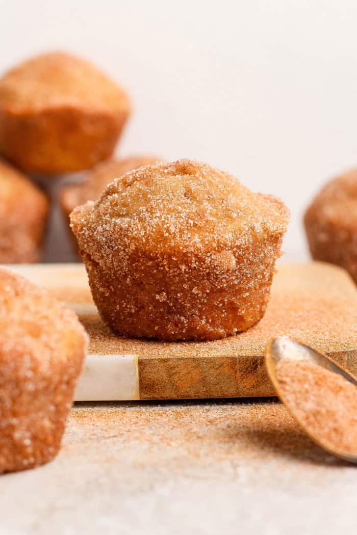 Closeup of cinnamon sugar doughnut muffin on wood board