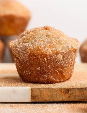 Closeup of cinnamon sugar doughnut muffin on wood board