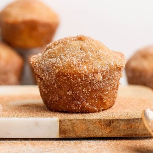 Closeup of cinnamon sugar doughnut muffin on wood board