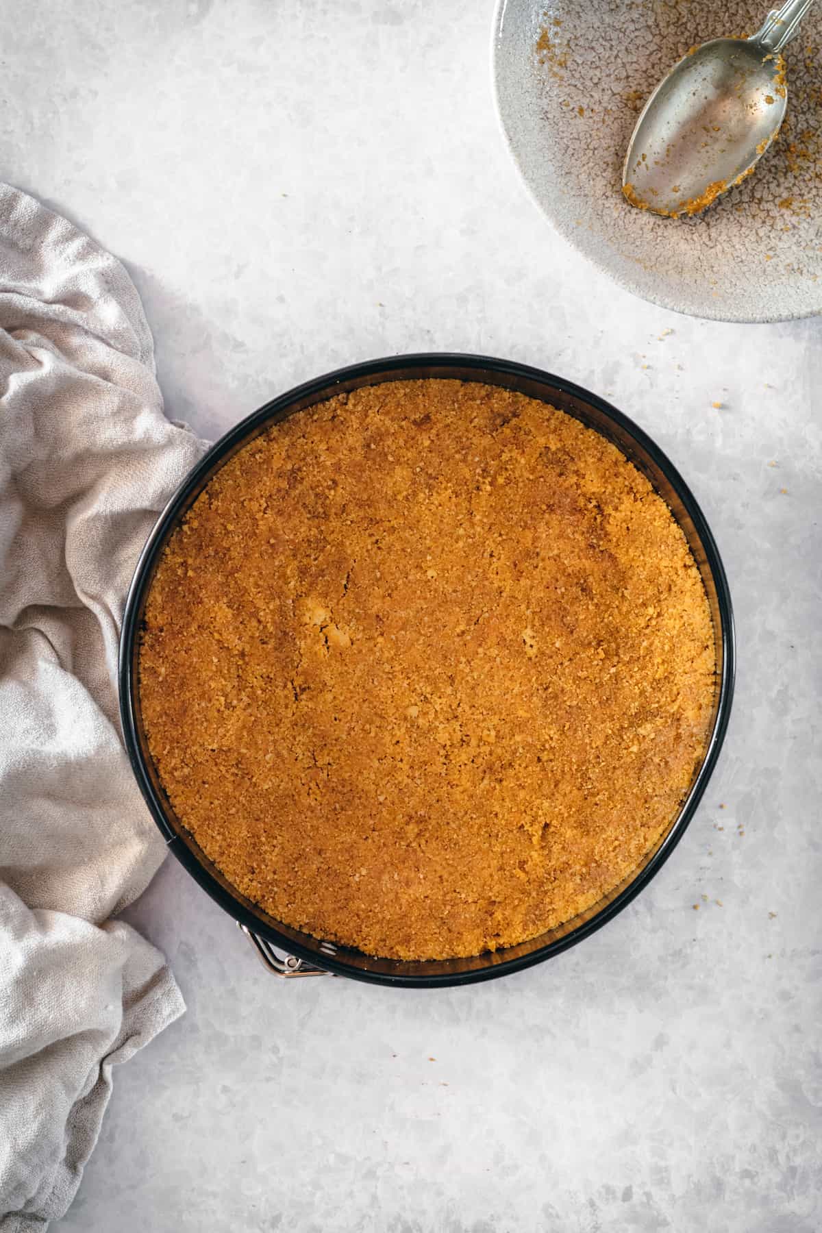 This is the best pumpkin cheesecake recipe! It's creamy, easy to make, and packed with pumpkin flavor, baked in a crunchy gingersnap crust. Gingersnap crust in a springform pan