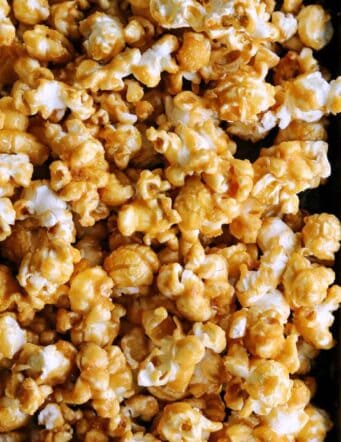 Caramel corn on a rimmed baking pan.