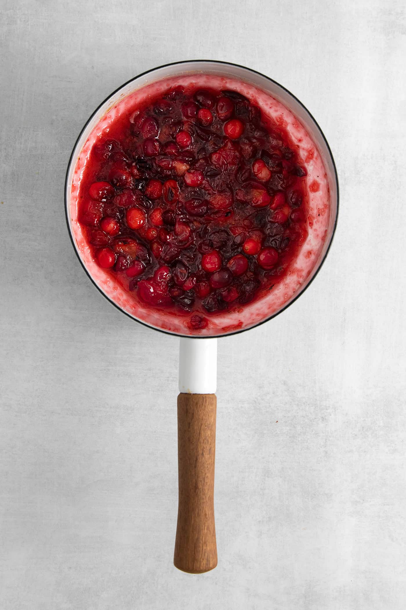 This Creamy Squash Soup with Cranberry Relish is made with squash, cream, warm spices and finished with a tart cranberry topping. Cranberry relish in a saucepan