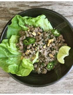 a pottery bowl of lettuce and ground pork