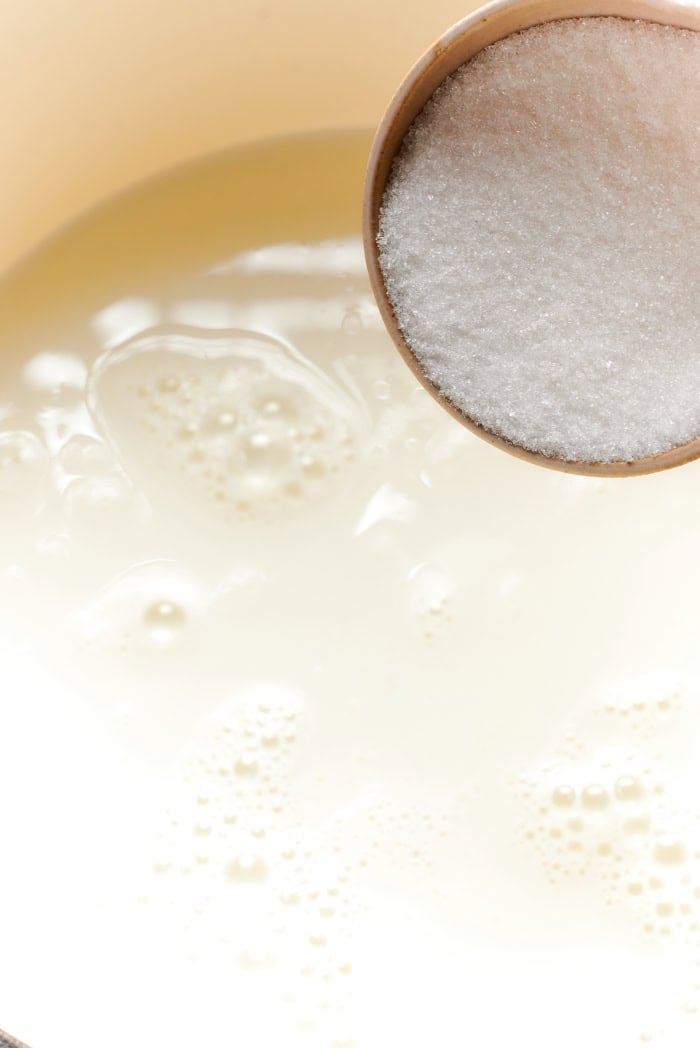This vanilla steamer recipe combines warm milk with cinnamon, vanilla and almond extract for a cozy drink to savor all winter long. Adding sugar to pan of warm milk