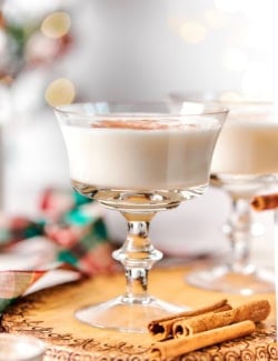 Vanilla steamer in glass with cinnamon sticks in foreground