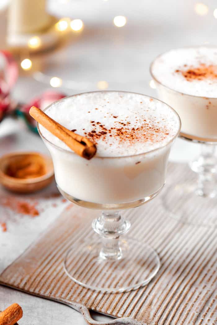 This vanilla steamer recipe combines warm milk with cinnamon, vanilla and almond extract for a cozy drink to savor all winter long. Vanilla steamer in glass with cinnamon stick