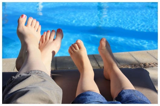 relaxing at the pool, with feet up on loungers