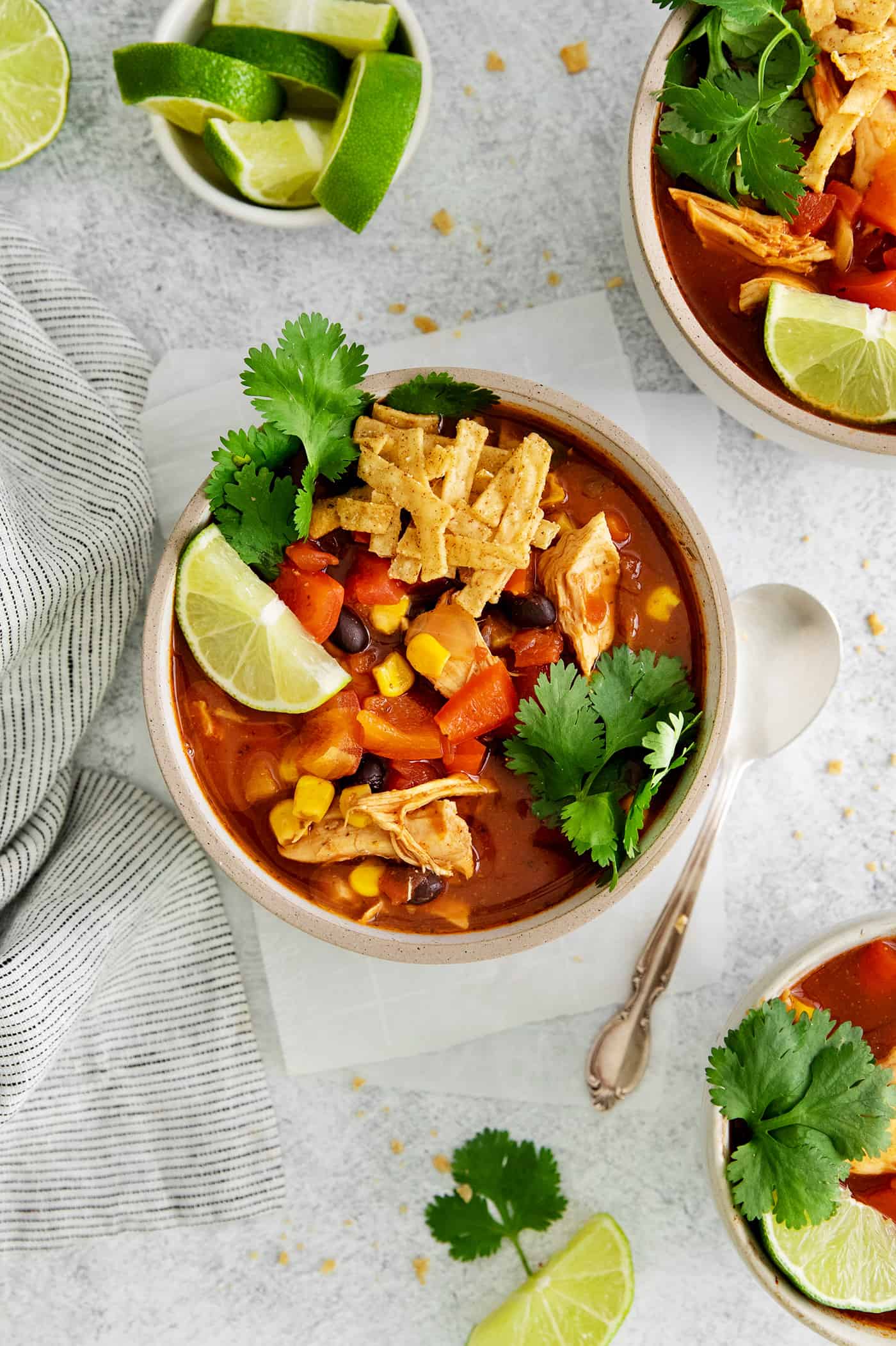 This easy chicken tortilla soup recipe is loaded with Mexican-style flavor, ready in 40 minutes! A perfect one pot soup recipe for weeknights! Overhead view of a bowl of chicken tortilla soup