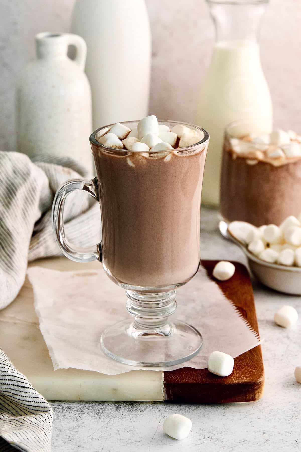 This recipe for homemade hot chocolate makes the creamiest and most decadent hot cocoa ever! It's easy to make and impossible to resist. Homemade hot chocolate in glass mug with marshmallows