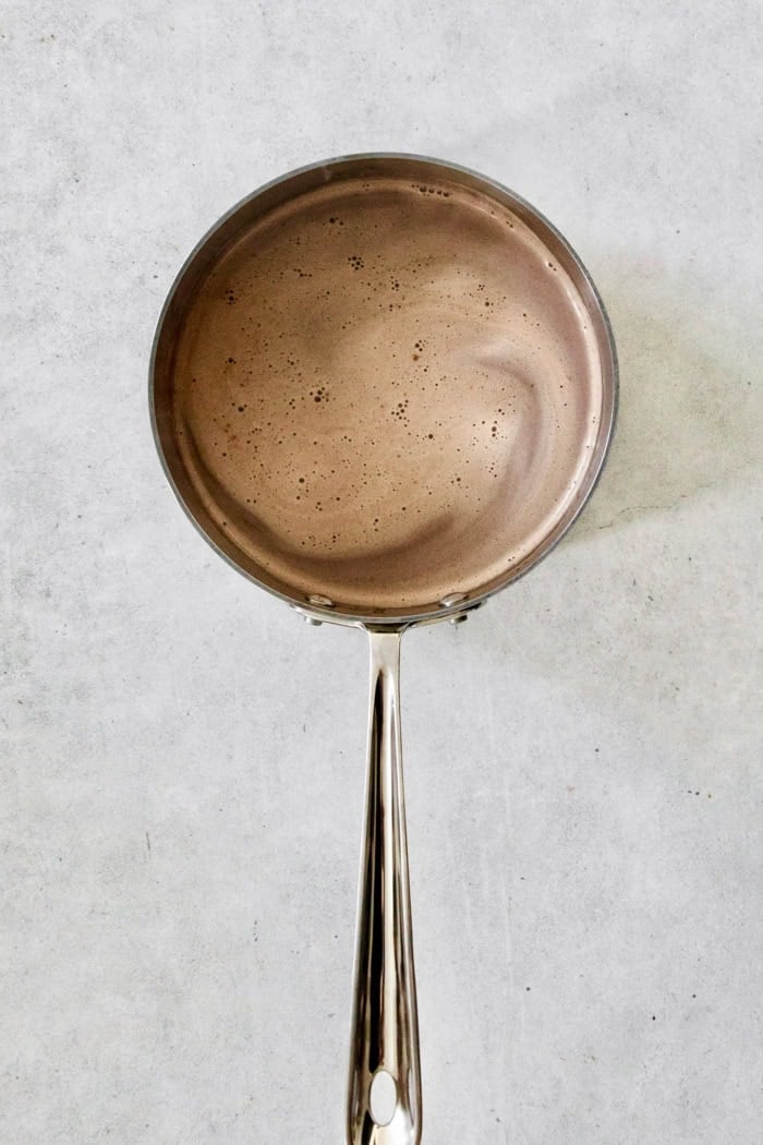 This recipe for homemade hot chocolate makes the creamiest and most decadent hot cocoa ever! It's easy to make and impossible to resist. Overhead view of hot chocolate in pan