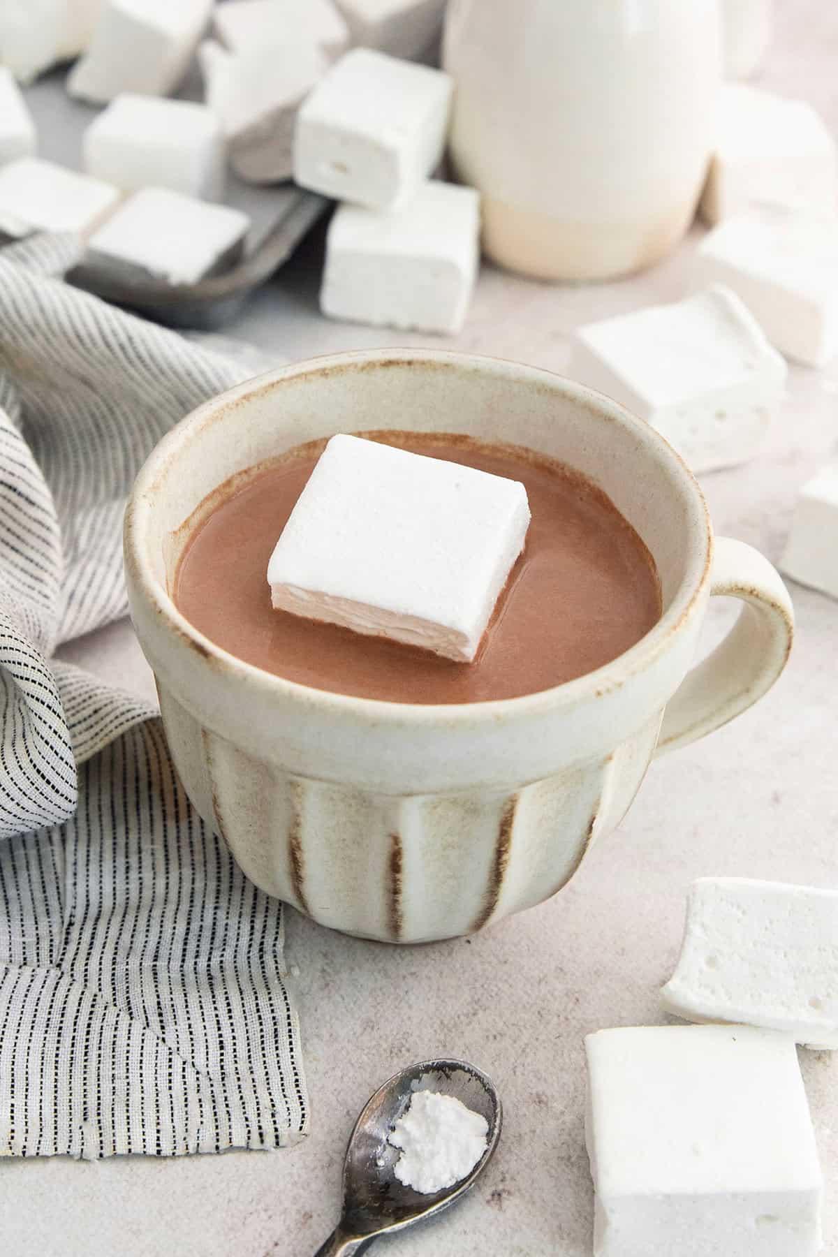 Homemade marshmallows are easier than you think! This recipe yields perfect fluffy marshmallows that are SO much better than store-bought. Homemade marshmallow in mug of hot chocolate