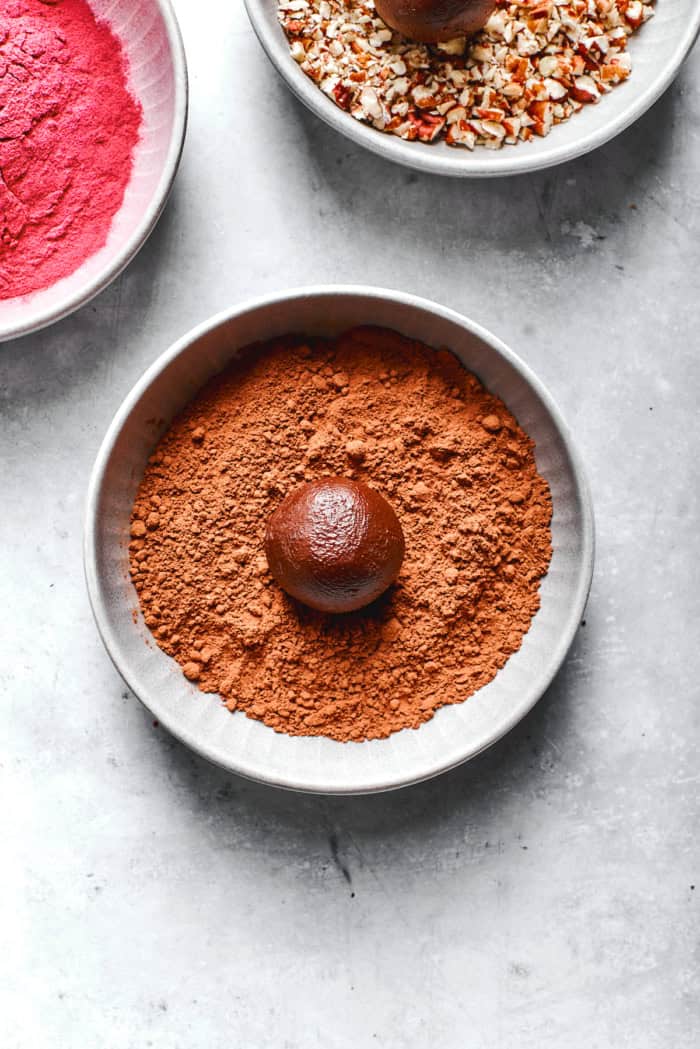 Melt-in-your-mouth Chocolate Truffles are an indulgence worth making from scratch. This easy recipe calls for only 6 simple ingredients! Rolling chocolate truffle in cocoa powder