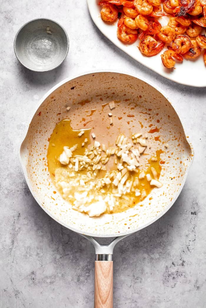 Rich without being heavy, garlicky with just a bit of heat, this Creamy Shrimp Pasta is a restaurant-worthy meal ideal for a date-night-in! Onion added to skillet with butter and oil.