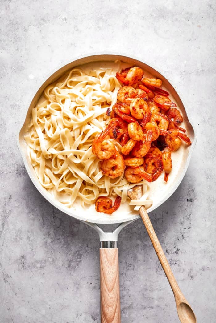 Rich without being heavy, garlicky with just a bit of heat, this Creamy Shrimp Pasta is a restaurant-worthy meal ideal for a date-night-in! Shrimp and pasta added to cream sauce.