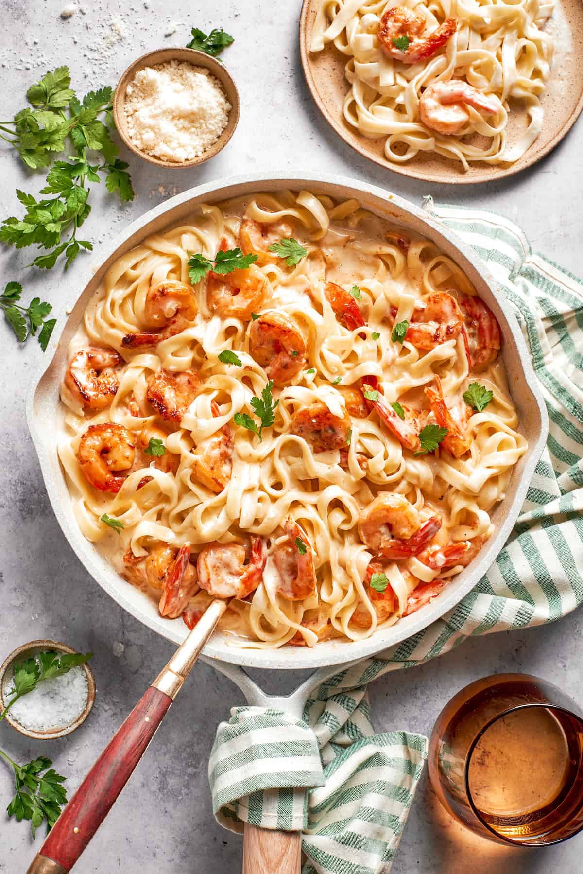 Rich without being heavy, garlicky with just a bit of heat, this Creamy Shrimp Pasta is a restaurant-worthy meal ideal for a date-night-in! Skillet with creamy shrimp pasta.