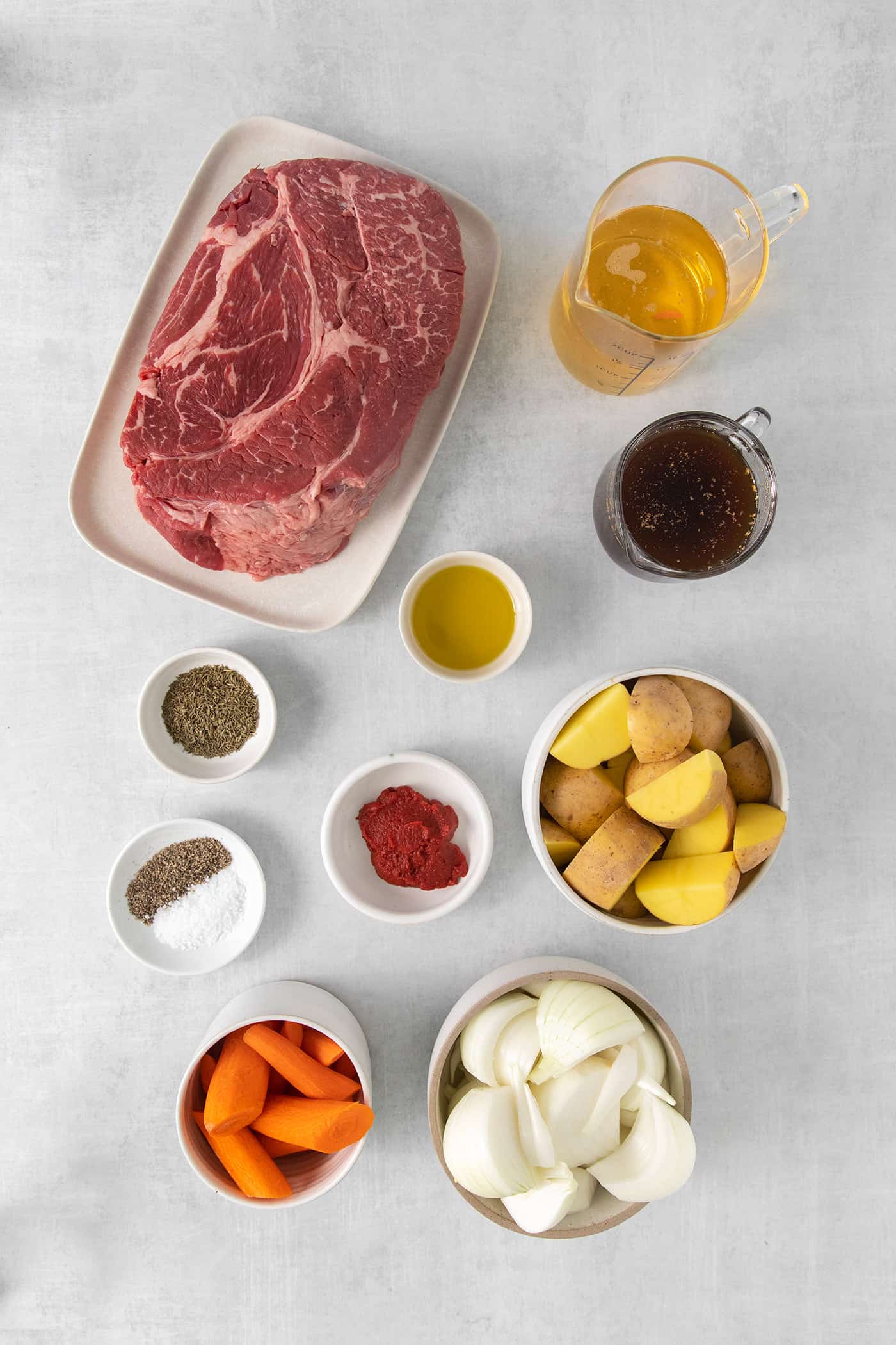 Made with chuck roast, potatoes, carrots, and onions in a beef broth, this Classic Pot Roast is comfort food at its finest. Hearty & filling! Overhead view of pot roast ingredients