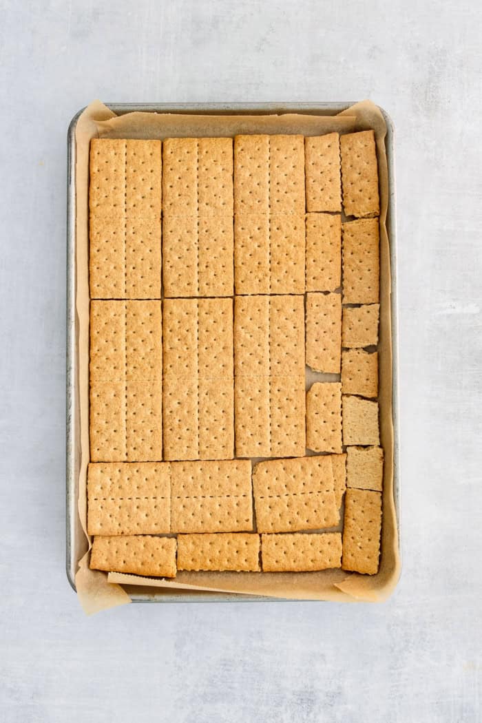 This homemade graham cracker toffee recipe with crunchy, buttery pecans is an easy 5-ingredient dessert for the holidays. Adding the layer of graham crackers in the baking sheet.