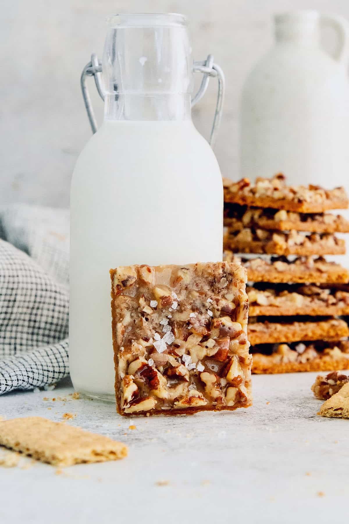 Close-up of a piece of toffee with graham crackers and pecans.