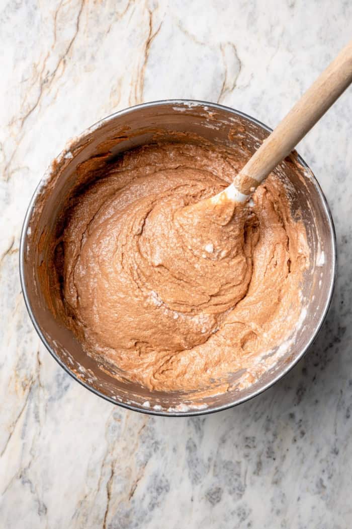 This classic German Chocolate Cake recipe is a moist, rich three-layer chocolate cake topped with a nutty coconut-pecan frosting. Perfection! Overhead view of German chocolate cake batter in bowl
