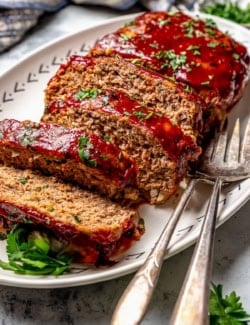 Slices of spicy meatloaf on platter.
