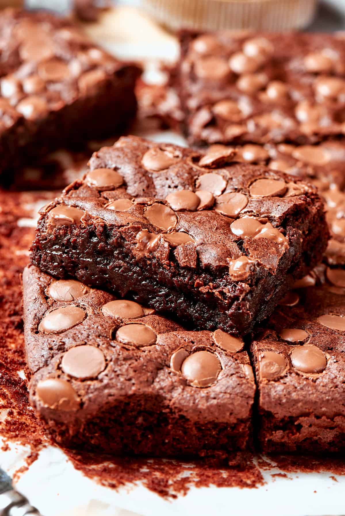 These fudgy brownies are a cinch to make with everyday pantry ingredients and the intensely fudgy texture and chocolate flavor is awesome! Fudgy brownie stacked on top of other brownies
