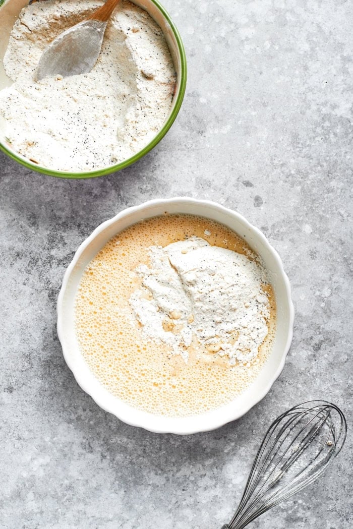 This moist orange poppy seed bread is soaked in a zippy citrus glaze for a bright, tender, bakery-style loaf perfect for brunch or gifting. Dry ingredients added to bowl of wet ingredients.