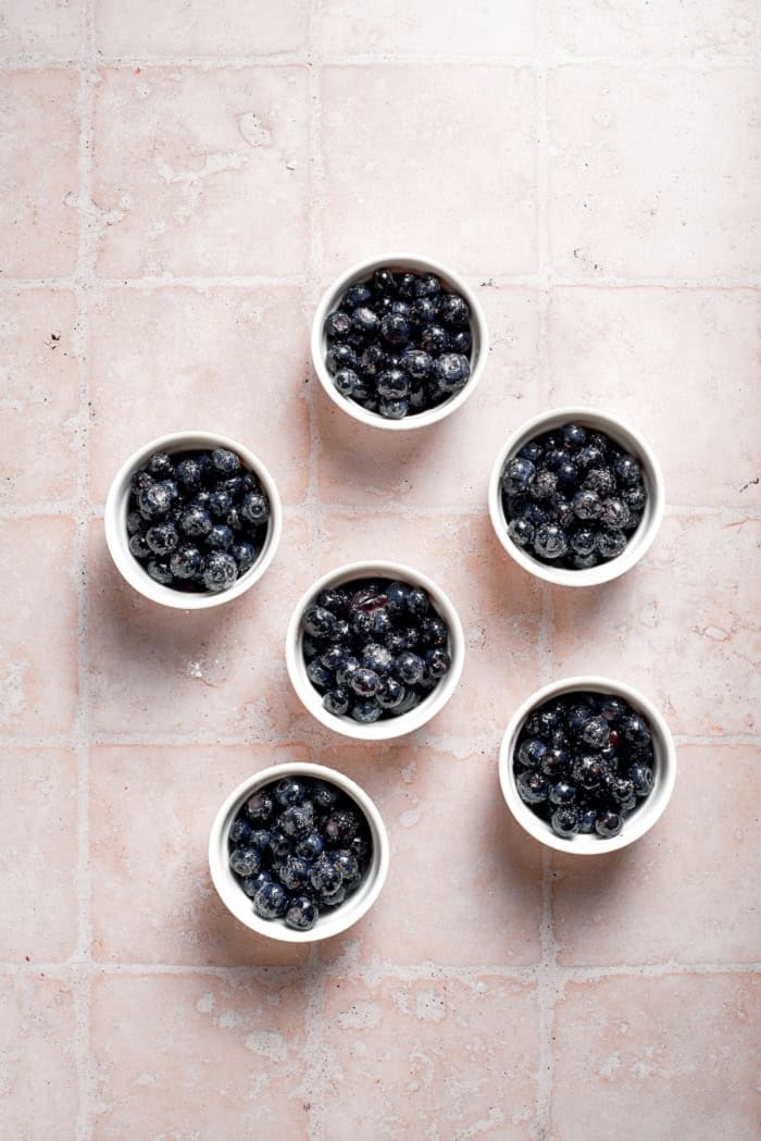 These mini blueberry cobblers are bursting with jammy berries and topped with a buttery, tender, flaky cobbler crust. An easy, rustic dessert! Blueberry filling in ramekins.