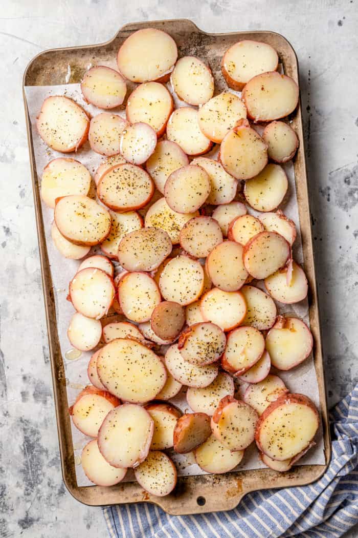 With smoky red potatoes and a rich blue cheese vinaigrette, this grilled potato salad recipe is so delicious, it might just steal the show! Overhead view of oiled and seasoned red potatoes