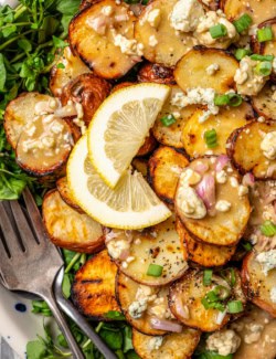 Overhead view of grilled potato salad on platter with two forks