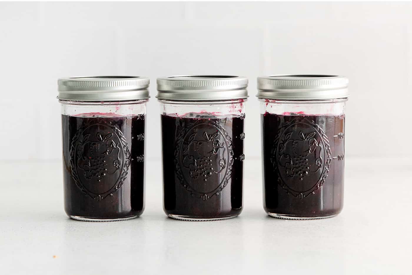 Made with just 4 ingredients, this Homemade Blueberry Jam with Mint is dark and fruity, with a sweet but cool and refreshing flavor. Three jars of blueberry jam with mint