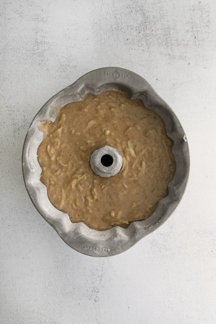 This easy apple bundt cake was made for fall baking! A moist and fluffy apple cake drizzled with an irresistible brown butter vanilla glaze. Cake batter in a bundt pan