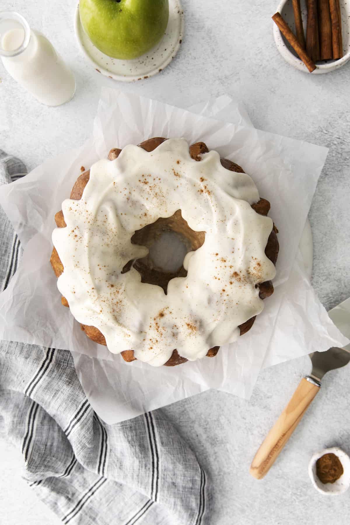 This easy apple bundt cake was made for fall baking! A moist and fluffy apple cake drizzled with an irresistible brown butter vanilla glaze. Top view of a glazed apple bundt cake