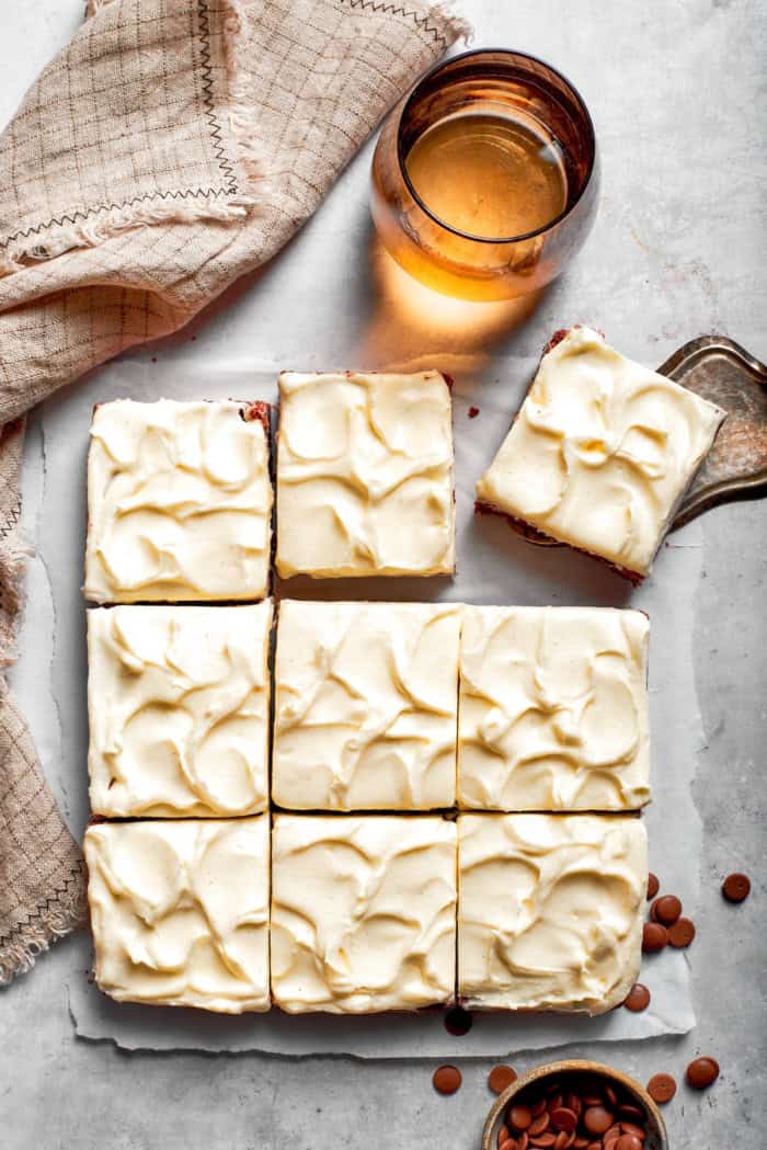 These Red Velvet Brownies are dense and fudgy, exceptionally moist, and fantastically rich. The cream cheese frosting on top is perfection! Overhead view of 9 sliced red velvet brownies