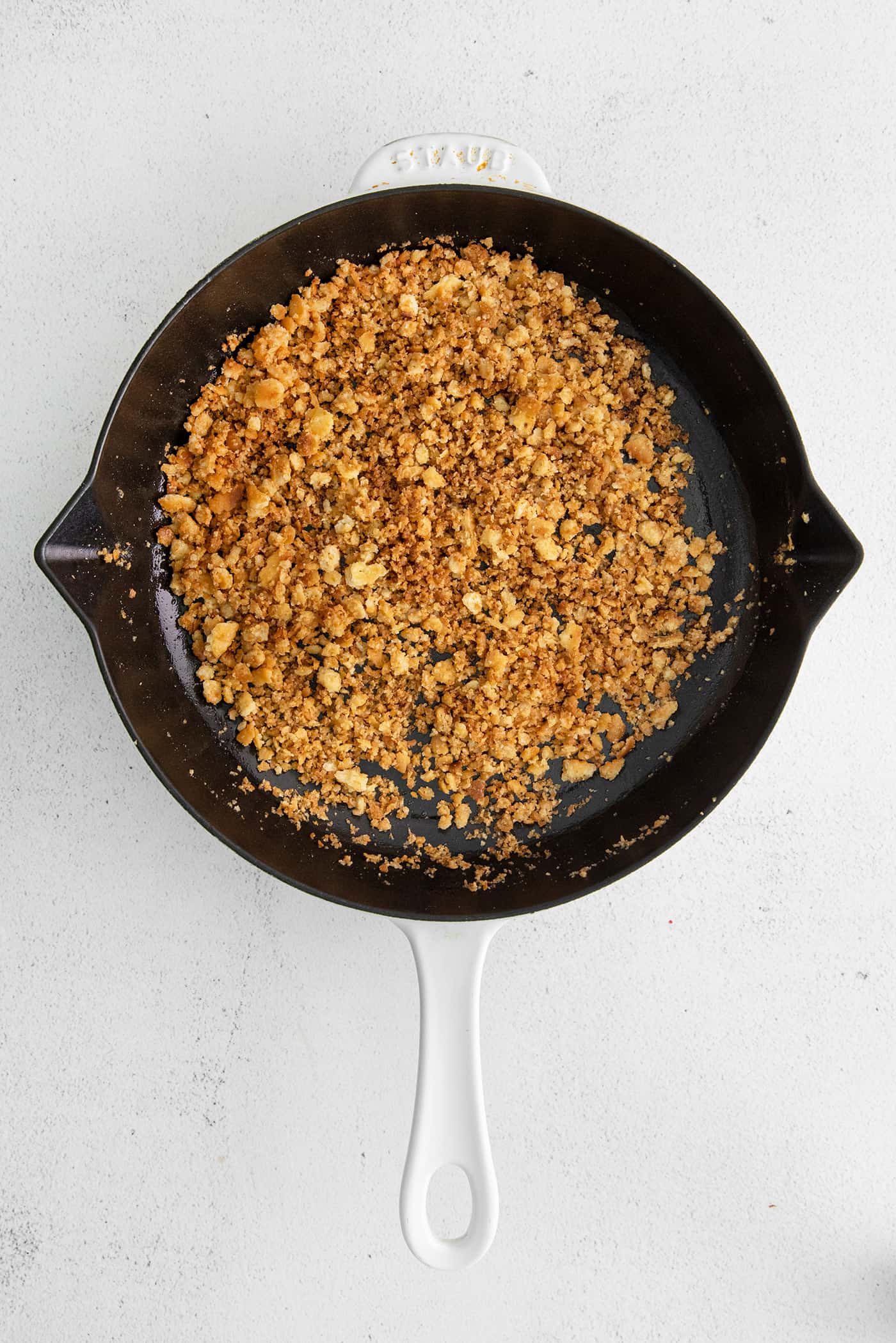 With 3 types of corn and a creamy Swiss cheese sauce, this Cheesy Skillet Scalloped Corn is a family favorite side dish! Ritz crumbs and butter in a cast iron skillet