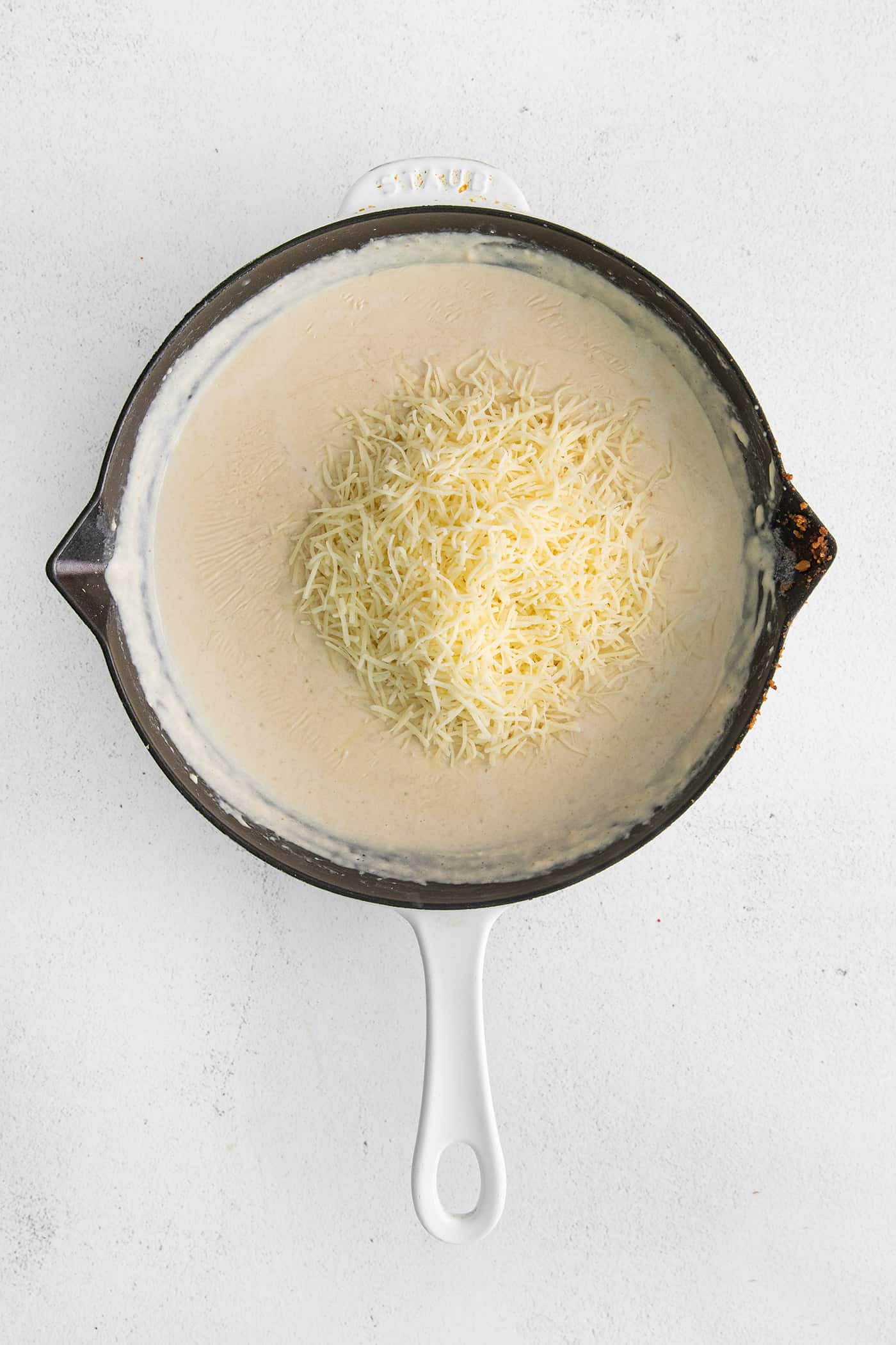 With 3 types of corn and a creamy Swiss cheese sauce, this Cheesy Skillet Scalloped Corn is a family favorite side dish! Shredded Swiss cheese with a flour roux in a cast iron skillet