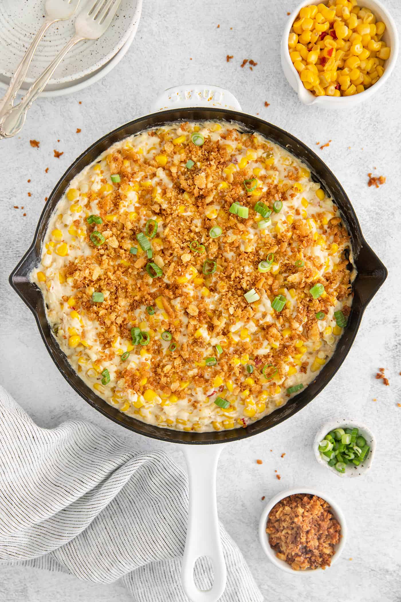 With 3 types of corn and a creamy Swiss cheese sauce, this Cheesy Skillet Scalloped Corn is a family favorite side dish! Overhead view of skillet corn