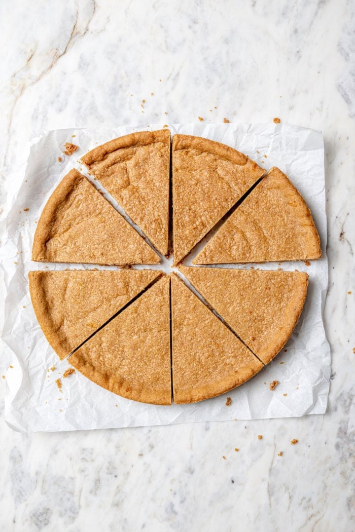 Full of warm spices, these simple spice cookies are a great addition to any holiday cookie platter. They're so easy to make too! Overhead view of spices cookies cut into wedges
