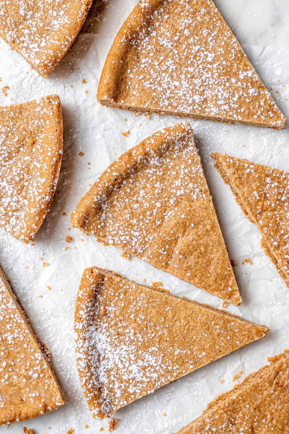 Full of warm spices, these simple spice cookies are a great addition to any holiday cookie platter. They're so easy to make too! Overhead view of spice cookies dusted with powdered sugar