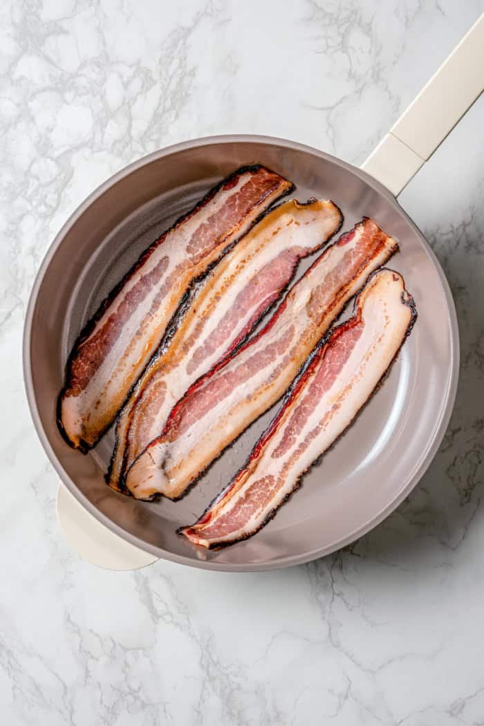 Overhead view of bacon in skillet