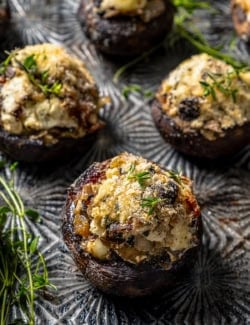 Stuffed mushrooms with bacon and blue cheese garnished with thyme