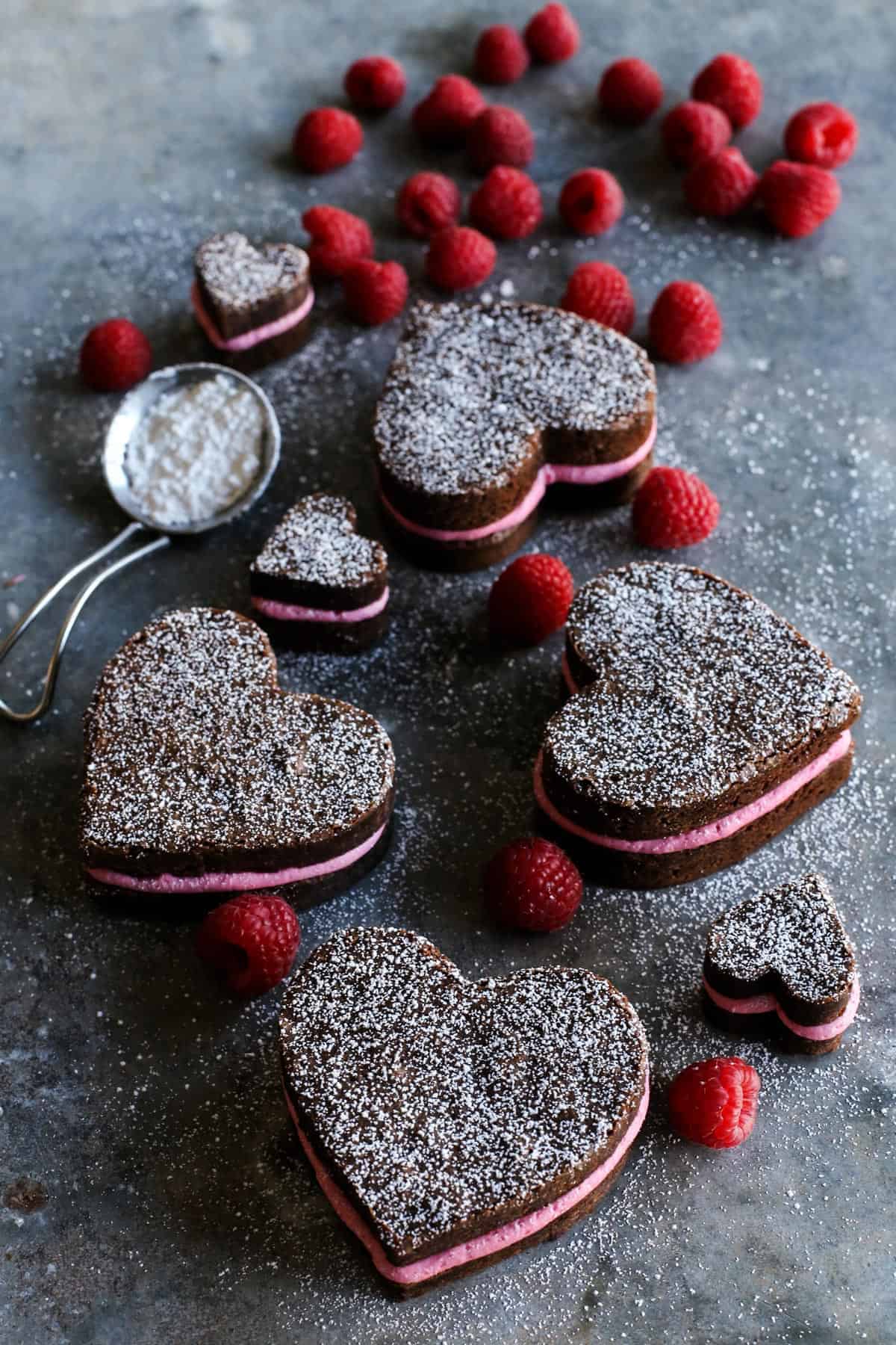 This heart shaped brownies recipe sandwiched with tangy raspberry-lemon buttercream is a super cute, chocolatey Valentine's Day treat. 4 large heart shaped brownies with buttercream and 2 small ones.