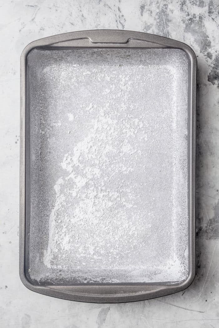 Homemade Marshmallow Hearts are the very best way to send a little love on Valentine’s Day — or any time of year. Fluffy, puffy, and sweet! Overhead view of pan dusted with powdered sugar