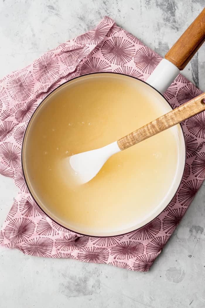 Homemade Marshmallow Hearts are the very best way to send a little love on Valentine’s Day — or any time of year. Fluffy, puffy, and sweet! Overhead view of syrup for marshmallows in pan